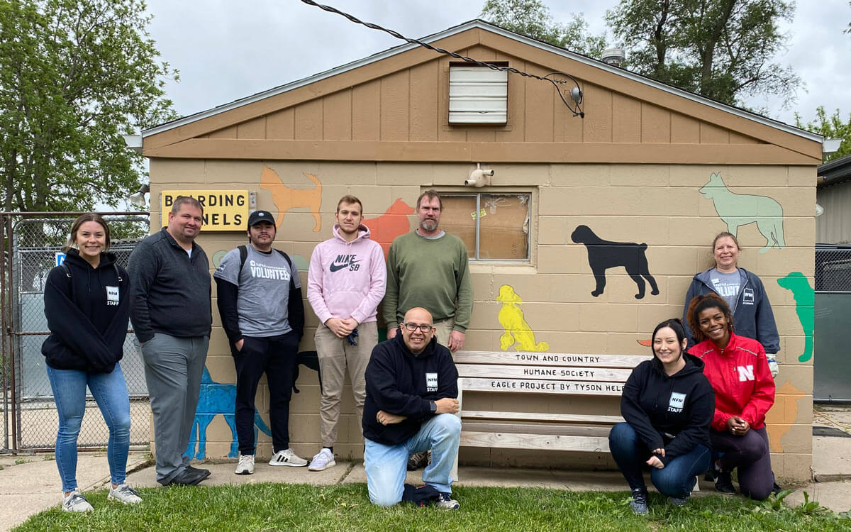 Group of NFM employees volunteering together at Animal Kennel