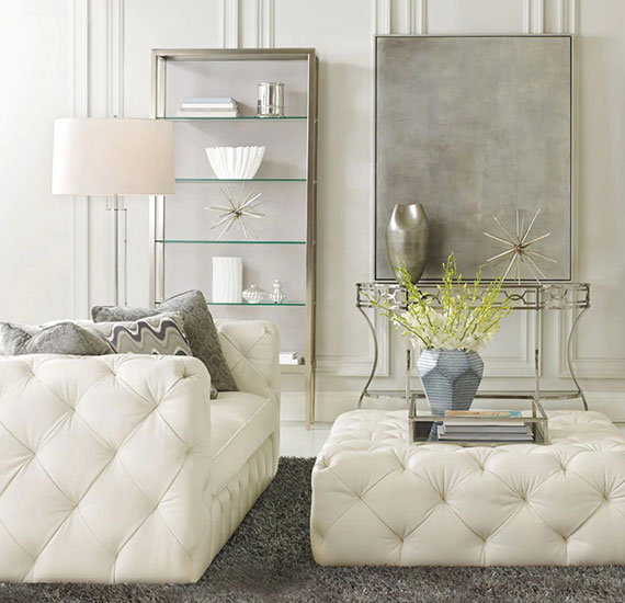 Living room interior design with silver and white furniture and gray accent decor.
